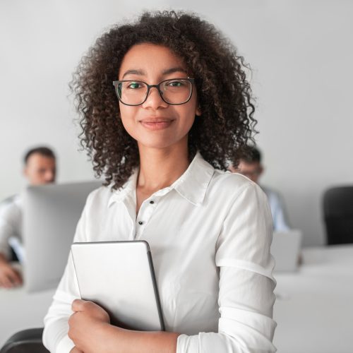 smiling-ethnic-female-recruiter-with-tablet-looking-at-camera-in-office.jpg